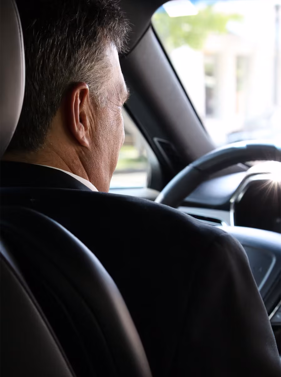 Maynard Limousine Service professional chauffeur driving a client to logan airport Maynard Limousine Service professional chauffeur driving a client to logan airport